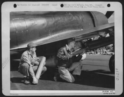 General > S/Sgt. Henry H. Yoder of Sonderton, Pa., and Sgt. Lloyd Dunker of Portland, Oregon, handle with the greatest of respect the rockets they are inserting into the launching tubes of an 8th Fighter Command. The rockets demand respect because of the great