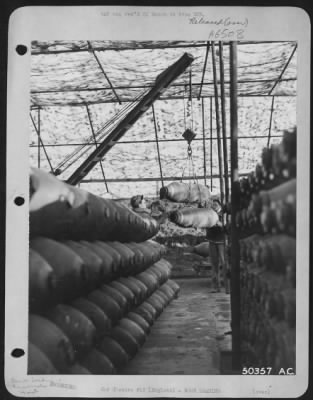 General > Another view of 500 lb bombs being hoisted into trailer by Sgt. Carlton Bennett, Towanda, Pa., (left) and Cpl. Jack L. Robson, Johnston, Pa.-England.