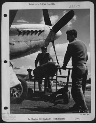 General > Cpl. Leroy Turner, of Altoona, Pa., (left and Sgt. Henry A. Bucko, of Hammond, Ind., caught wheeling out a bomb trailer with a 500 pounder under the nose of a P-51 Mustang "Yahootie Too" for loading on the plane flown by 1st Lt. John R. Bernert