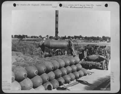 General > ENGLAND-Stacked up two thousand pound bombs loaded on a trailer for delivery to a bomb bay of a Consolidated B-24 which will forward them to Germany (K2385).