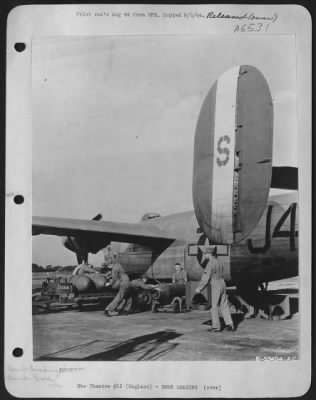 General > An Ordnance crew loading two thousand pound bombs on a B-24 Liberator somewhere in England. (Kodachrome #2384)