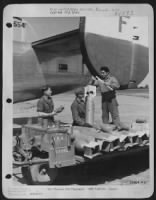 Loading bombs in Liberators prior to an operational flight is the job of three ordnance men, member of a group commanded by Col. Luther J. Fairbanks of Burt, Iowa. Left to right: Pfc Jean F. Pentz, 1307 Seventeenth Street, Anacortes, Washington; Cpl. - Page 1