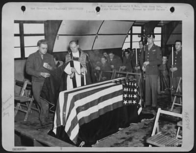 General > In a symbolic ceremony, soldiers of Catholic faith pay tribute to missing and dead airmen in Catholic worship services conducted by Chaplain Patrick J. MacDwyer of Ill-50 117th St., Ozone Park, L.I., N.Y.: in a Nissen hut chapel at a Consolidated