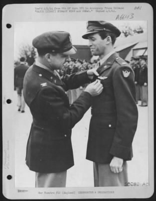 Awards > ENGLAND-Major James M. Stewart, Indiana, Pennsylvania, receives the Air Medal from Colonel Paul Schwartz, 1720 Watros Ave., Tampa, Florida. The ceremony is being conducted at a Liberator base of the U.S. Army Air forces somewhere in England.