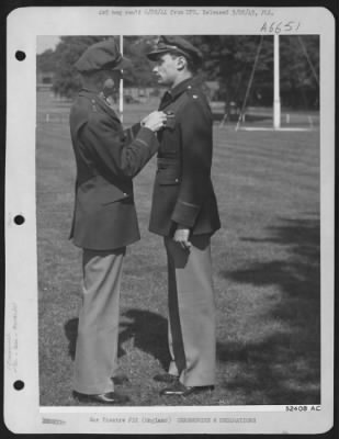 Awards > ENGLAND-General Carl A. Spaatz, Commanding General of Strategic Air forces in Europe pins Distinguished Service Cross on Major James A. Goodson of Toronto, Ontario, Canada, "for extraordinary heroism in action with the enemy." On two separate
