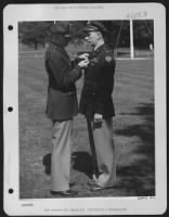 ENGLAND-Genearl Carl Spaatz presents Distinguished Service Cross to 1st Lt. Edwin R. Herron of Little Rock, Arkansas. While serving as a pilot of an 8th AAF Bomber his plane received a direct flak hit which damaged it seriously and injured four crew - Page 1