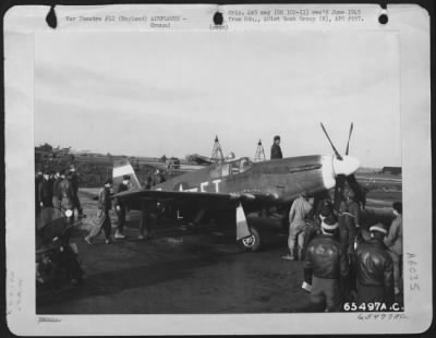 North American > Men Of The 401St Bomb Group Look Over A North American P-51 "Mustang" At An 8Th Air Force Base In England, 27 December 1943.