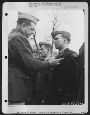 Unidentified > Brig. General John P. Doyle presents an award to a member of the 320th Bomb Group during a ceremony at an airbase at Dijon, France. 1945.