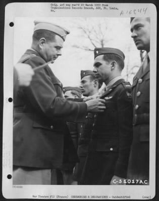 Unidentified > Brig. General John P. Doyle presents an award to a member of the 320th Bomb Group during a ceremony at an airbase at Dijon, France. 1945.