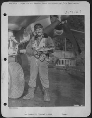 Gunner > The ingenuity of Sgt. Arland E. DuVall of Brigham City, Utah, saved his Martin B-26 Marauder "Heaven Can Wait" from a crash-landing in France. The engineer-gunner is shown holding the bomb-hoist and cable which he used in lowering the plane's nose