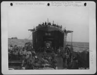 A Navy LST boat with its yawing doors is pictured on the Northern Coast of France unloading its supplies, vehicles and men to keep up the constant flow from England. These boats shuttle back and ofrth day and night under an air cover - Page 1