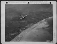 One of the many B-26 Martin Marauders of the Ninth Air force is shown over the coast of France during the early morning giving a cover to the landing craft shown on the sandy beaches below. These hard hitting medium bombers with their fighter escort - Page 1