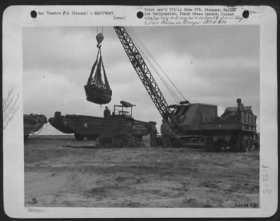 General > Giant cranes unload high octane gasoline for the 9th AF from ducks and lower it into army trucks which will speed to advanced landing strips.