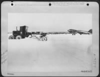 The air freight must go through regardless of the elements. A First Tactical AF Air Depot cargo plane stands by while the Aviation Engineers clear the runways at a snow-covered airfield somewhere in France. - Page 1