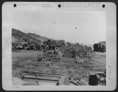 Thumbnail for Supplies > Truck drivers of the Ninth Air Force Service Command unload crates of ammunition at a supply dump in France. The American-built fields are already in use refueling and servicing planes which take off from there to strafe the enemy.