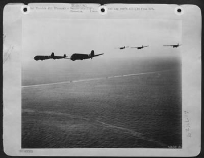General > On "D-Day" Douglas C-47 Troop carrying planes of the 9th AF, towing gliders loaded with airborne infantry are on the way to the French coast to participate in the initial assault behind enemy lines, while down below naval units make their way toward