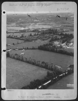 General > Cross section of the massive glider landing operations at a French objective of the U.S. Army 9th AF. Gliders and tow planes can be seen circling, and, at left, gliders which have already landed are seen close together. Note smashed gliders there and