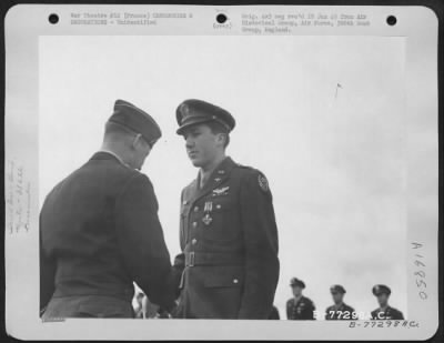 Unidentified > Major General Samuel E. Anderson Congratulates An Officer Of The 386Th Bomb Group After Presenting Him The Distinguished Flying Cross During A Ceremony At An Air Base Somewhere In Beaumont, France.  15 March 1945.