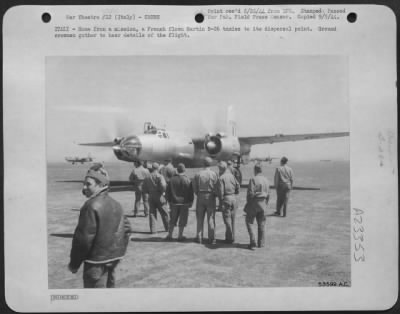 Consolidated > ITALY-Home from a mission, a French flown Martin B-26 taxies to its dispersal point. Ground crewmen gather to hear details of the flight.