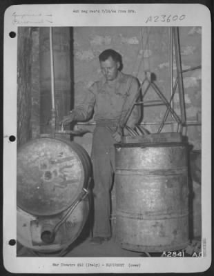 Consolidated > ITALY-Photographic report of improvised sanitary devices. Gasoline drums in left of photo are used as heating unit for dish washing device. Materials for heating unit: 40-feet 3/4 inch pipe and fittings or 1 1/2 inch tubing salvaged from planes many