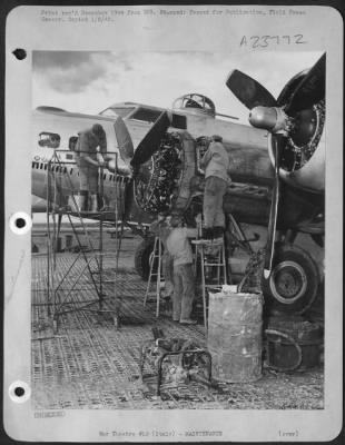 Consolidated > ITALY-Bombers require loving care and speedy attention from ground maintenance men to keep 'em flying. Here an engine crew works wurely and swiftly to repair flak damage.