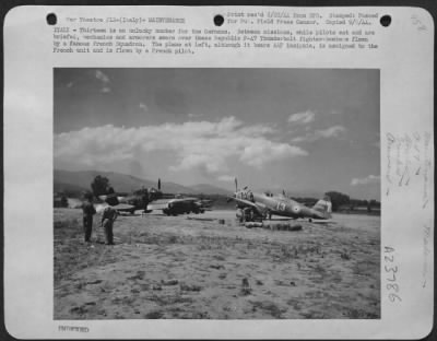 Consolidated > ITALY--Thirteen is an unlucky for the Germans. Between missions, while pilots eat and are briefed, mechanics and armorers swarm over these Republic P-47 Thunderbolt fighter-bombers flown by a famous French Squardron. The plane at left, although it