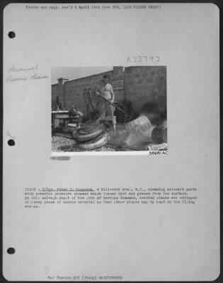 Consolidated > ITALY-T/Sgt. Peter J. Kasprzyk, 4 Hillcrest Ave., N.Y., cleaning aircraft parts with powerful pressure cleaner which forces dirt and grease from the surface. At this salvage depot of the 15th AF Service Command, wrecked planes are stripped of every