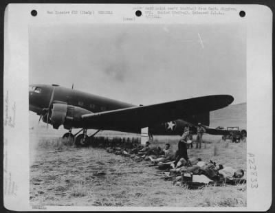 Thumbnail for Consolidated > Wounded Italian and Allied soldiers waiting under wing of a Douglas C-47 to be flown to hospital in Africa.