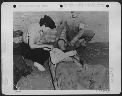 Consolidated > Nurse Verona Savinski, 802nd Medical Air Evacuation Transport Squadron and Cpl. Claude W. Thomas, 3rd Auxiliary Surgical Group, with PFC Joe Hirsch of Brooklyn, N.Y., 504th Paratroops Infantry, who was strafed while rushing to the front after jumping