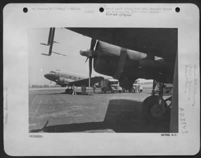 Thumbnail for Consolidated > Wounded being taken from the aircraft by ambulances at a base airfield in Italy.