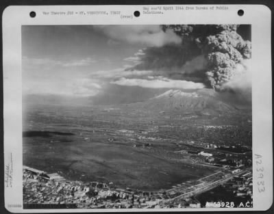 Consolidated > Airfield at the base of Mt. Vesuvius, Italy. In the background is Mt. Vesuvius just before the eruption on 23 March 1944.