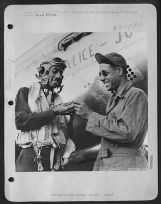 Consolidated > ITALY-Captain Wendell O. Pruitt, 23m, of St. Louis, Mo., one of the leading pilots in the 15th Air Force makes sure that he leaves his valuable ring with his smiling crew chief, S/Sgt Samuel W. Jacobs, 24, of Los Angeles, California.