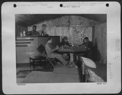 Consolidated > ITALY-This cozy home, built in six days by Sgt. Fred Robinson of Yorktown, Virginia, boasts hot and cold running water, sink, poker table and service bar. Left to right: Sgt. Fred Robinson; Maj. Elmer D. Jones, Jr., Washington, D.C.; 1st Lt. John