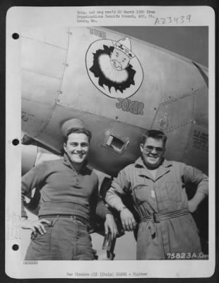Consolidated > Two Ground Crew Members Of The 94Th Fighter Squadron, 1St Fighter Group, Pose Beside Their Lockheed P-38 Lightning At An Airfield Somewhere In Italy.  ['The Joker']