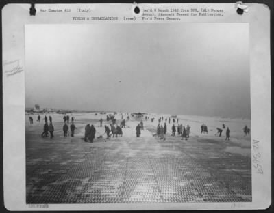 Consolidated > Magnitude Of Work Confronted By American Aviation Engineers After A Voilent Snowstorm Over This Below-Sea-Level Airfield In Italy Can Be Seen By This Runway Being Cleared.  Two Hours Earlier The Field Was Buried In Snow.  But Engineers Made It Possible Fo