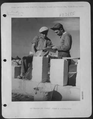 Consolidated > Left, An Italian Laborer, And Right, Sgt. David J. Pulizzi, From Chicago, Ill., A Welder At A 15Th Af Base, Go Over The Plans For A Stone Villa.  The Gi'S At This Base Holed Up For The Winter In Comfortable Little Villas That They Built Themselves.  The B