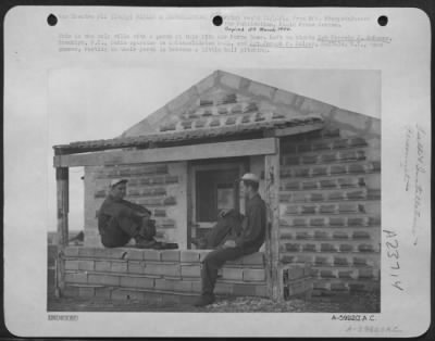 Thumbnail for Consolidated > This Is The Only Villa With A Porch At This 15Th Af Base.  Left To Right: Sgt. Francis J. Mckenna, Brooklyn, Ny., Radio Operator On A Consolidated B-24 Liberator, And Sgt. Joseph F. Halper, Buffalo, Ny, Nose Gunner, Resting On Their Porch In Between A Lit