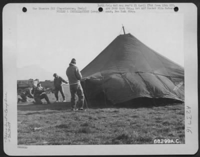 Consolidated > These Men Of The 79Th Fighter Group In Capodichino, Italy, Put Their Tent Up While A Strong Wind Is Blowing.  Mt. Vesuvius Can Be Seen In The Background.