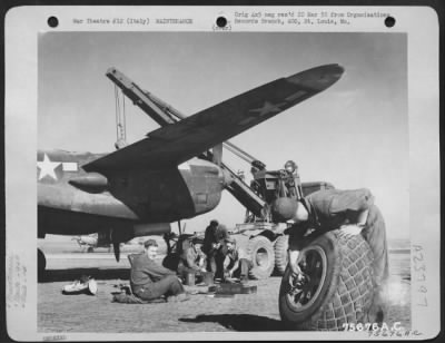 Consolidated > Maintenance Men Of The 94Th Fighter Squadron, 1St Fighter Group Work On A Lockheed P-38 Lightning At An Airfield Somewhere In Italy.