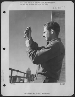 Consolidated > Sgt. Theodore H. Rhodes Of Safford, Arizona, Whirls The Psychrometer Through The Air To Take A Reading At The Mediterranean Allied Air Force Station, 15Th Af Headquarters In Italy.  The Psychrometer Indicates Air Temperature And Dew Point.