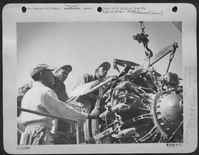 Consolidated > Busy At The Ticklish Job Of Removing An Aircraft Engine From The Engine Seat In The Wing, Are Three Aircraft Mechanics Of The All-Negro Service Group.  L. To R. Are, Sgt. Bonnie D'Garden, Of 270 Hudson, St., Jackson, Misissippi; Sgt. Thomas L. Greggs, 191
