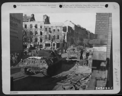 Consolidated > The first tanks and tank destroyers enter Aachen, Germany, where fighting still continues, shortly after Artillery batteries and 9th AF dive-bombers had bombarded enemy positions. Destruction visible in the picture resulted from the combined power of