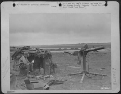 Consolidated > T/5 Philip Gilleo of Mountville, N.Y., an anti-aircraft gunner guarding one of the 9th AF Airstrips in Germany, catches up on his reading as he uses a Jerrican for a seat in front of his "straw" shelter.