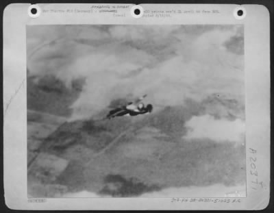 Thumbnail for Consolidated > Burning Liberator Disintergrates in Air: A victim of a direct hit by flak, these two photos graphically portray the final plunge of a B-24 Liberator of the U.S. 8th AF during the March 20th attack on Frankfurt. One of the six bombers which failed to