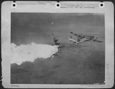 Consolidated > OVERTURNED LIBERATOR-Bombs tumble from the bays of an overturned Liberator bomber of Major General Nathan F. Twining's 15th Air Force when the plane is caught in a heavy flak belt as it makes its bomb run over Blechhammer, Germany.