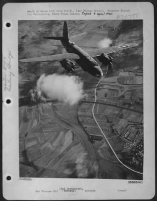 Consolidated > FRANCE--A Martin B-26 Marauder wings homeward after bombing the Bad Oeynhausen railway bridge over the Weser River, 40 miles southwest of Hannover. The Ninth Air Force Bombers, attacked the bridge, partially hidden by a cloud and marked by a