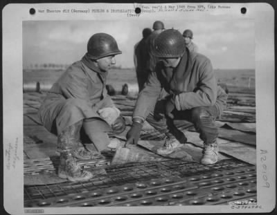 Consolidated > Aviation Engineers Laying Steel Planks For An Airstrip On A Former German Base.