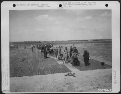 Consolidated > Pierced Steel Plank Is Laid By 834Th Engineer Aviation Battalion On The Airfield At Furth, Germany.