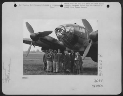 Consolidated > Germany -- Standing In Front Of Their Heinkel 111 Twin-Engine Bomber, These Eleven Camera-Shy Luftwaffe Members And One Civilian Took Off From The Lubeck Area And Landed At A 9Th Air Force Base.  They Surrendered To Guards Of The 16Th Air Depot Group.
