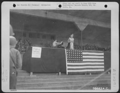 Consolidated > Grace Moore Enthralls Members Of The 834Th Engineer Aviation Battalion As She Sings At The Sports Stadium In Nurnberg, Germany.